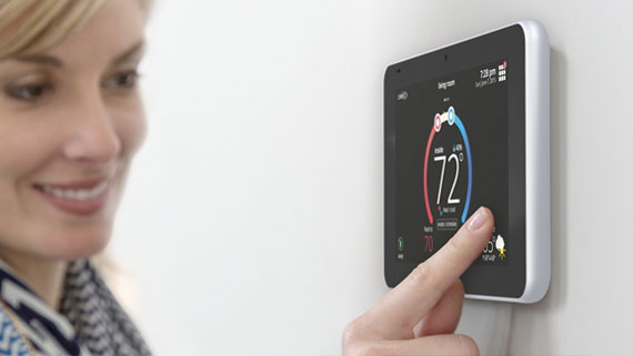 lady using smart thermostat